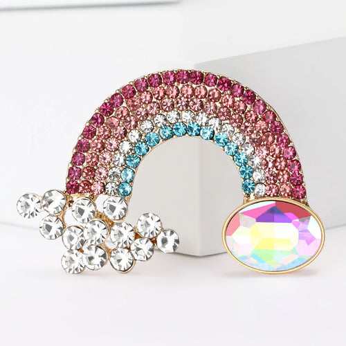 Front view of a curved pink and blue crystal rainbow with a cloud and iridescent gem