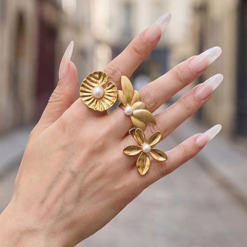 Grouped style view of oversized pearl center flower rings in main image 2.