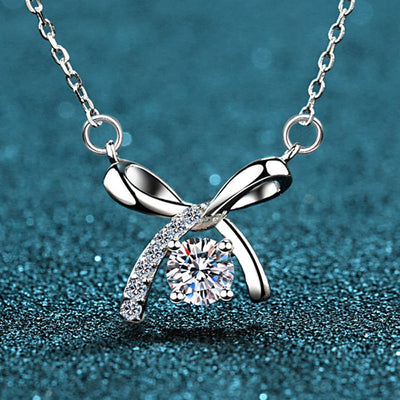 silver tone necklace showing small bow pendant with clear pavé-style accents