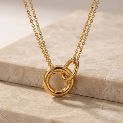 Neckline view of round geometric pendant necklaces in main image 1.