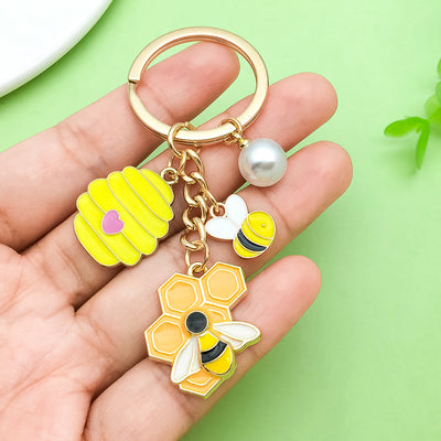 Image 1 showing a hand holding a keychain with two different designs.