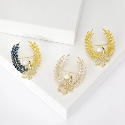 Front view of a wheat wreath with a white pearl and crystal bow