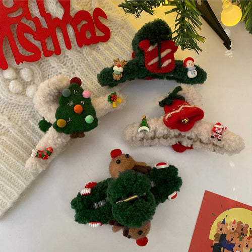 Four Christmas yarn claw clips tree gift reindeer styles flat lay