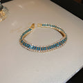 Gold Tone Three Row Bracelet With Teal And Clear Crystals view 6
