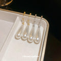 White Teardrop Dangle Earrings In Gold And Silver With Decorative Details view 2