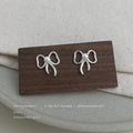 Silver Outline Bow White Pearl Center Stud Earrings Pair Style view 4