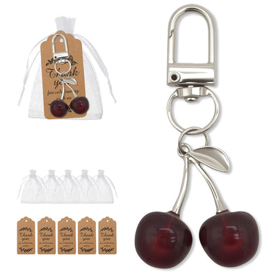A packaged cherry keychain is shown beside rows of sheer bags and brown thank-you tags.