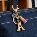 Gold Tone Initial Letter Keychain with Evil Eye and Pink Tassel view 3