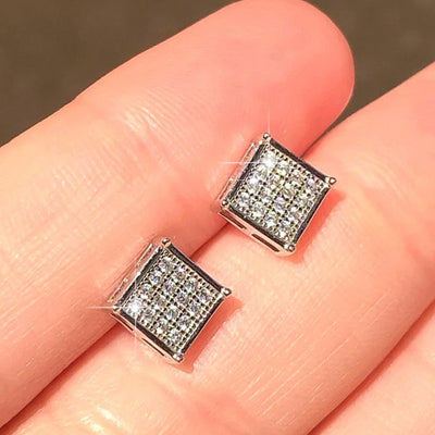 Silver square pavé CZ cube stud earrings held on fingertips