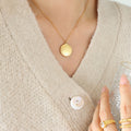 Gold Round Coin Pendant Necklace with Engraved Cherub Angel Motif view 4