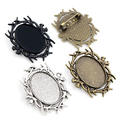Front overview of oval vine frame brooch settings in four metal tones arranged on a light background