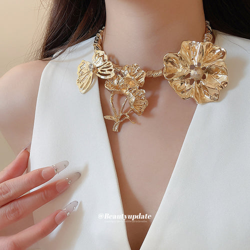 Gold twisted butterfly flower collar necklace worn on neck