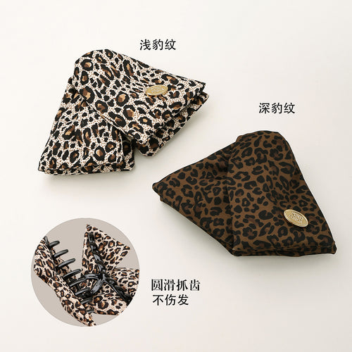 Light and deep leopard fabric triangle clips with claw detail inset