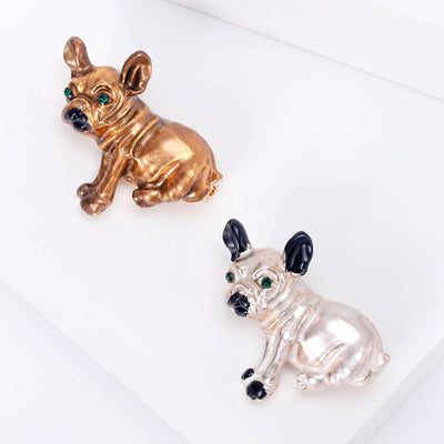Front view of the small dog brooch in brown or white enamel with polished metal detail on a white background