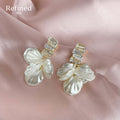 Gold Tone Clear Stone Bar And Translucent White Petal Stud Earrings view 1