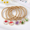 Gold Tone Beaded Clear Resin Pressed Flower Charm Bracelets view 1