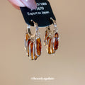 Amber Oval Crystal Cluster Silver Tone Hoop Earrings view 1