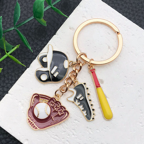 Styled close-up of black red and blue baseball charm keychain showing colors and surface details