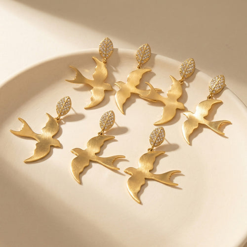 Grouped style view of polished swallow drop earrings in main image 2.