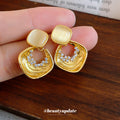 Gold Tone Geometric Drop Earrings With Pale Stone Centers view 1