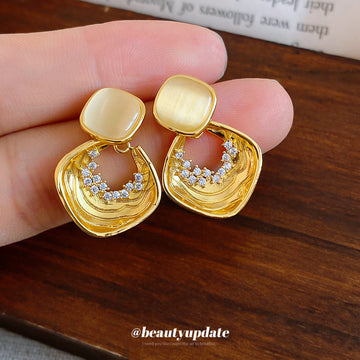 Gold Tone Geometric Drop Earrings With Pale Stone Centers