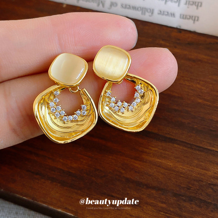 Gold Tone Geometric Drop Earrings With Pale Stone Centers