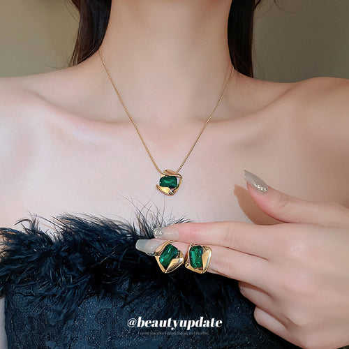 green rectangular pendant necklace and matching earrings shown worn