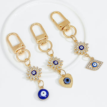 Gold-Tone Rhinestone Flower Evil Eye Charm Bag Keychain