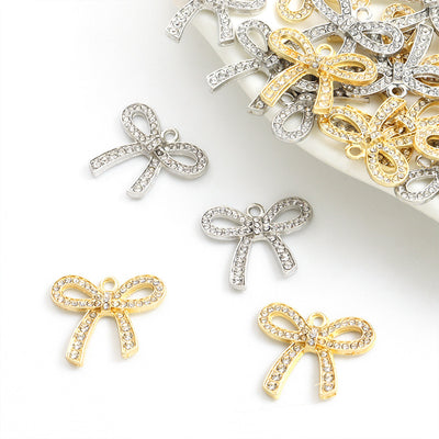 Assorted bow charms arranged on a white surface