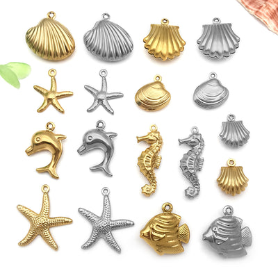 Gold-tone seahorse and dolphin charms arranged on a light background