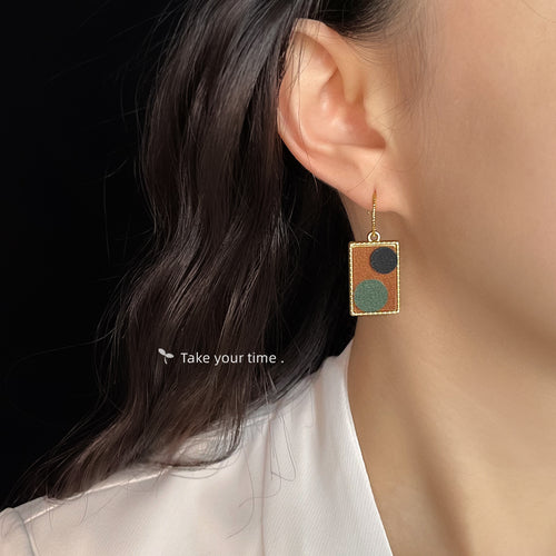 Rectangle fabric dangle earring worn on ear side profile