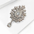 Teardrop Glass Brooch With Ornate Antique Tone Crystal Frame view 3