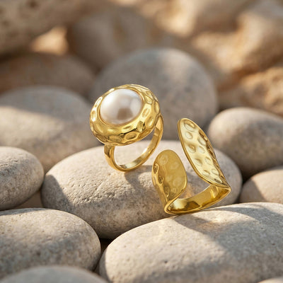 Gold pearl hammered ring and open double-panel ring on river stones
