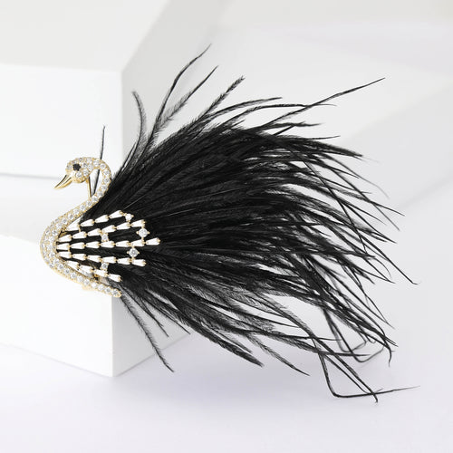 Black feather crystal swan brooch side angle on white blocks