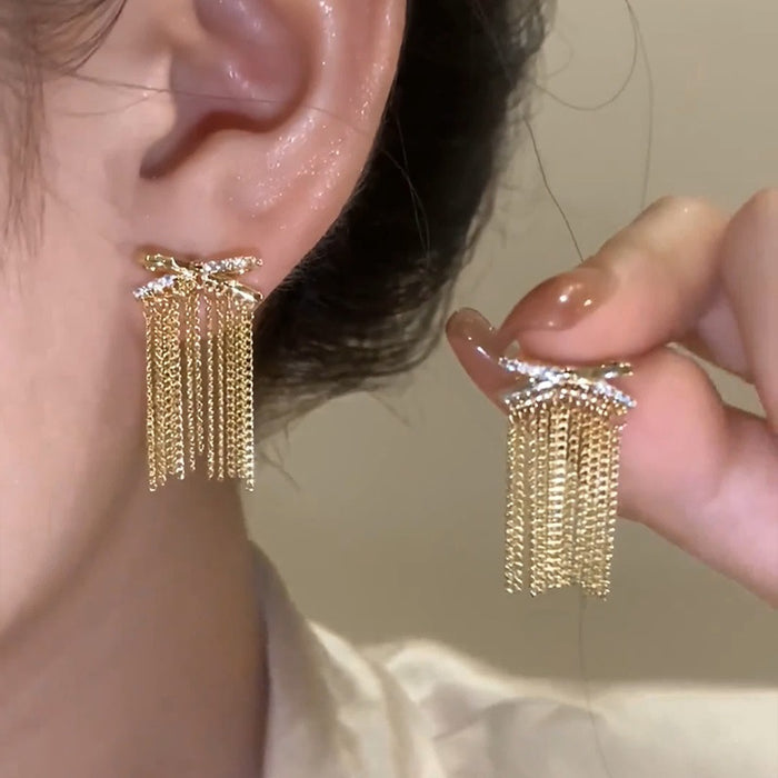 Crystal Bow and Gold Chain Fringe Stud Earrings With Metal Details