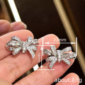 Silver Tone Bow Stud Earrings with Clear Baguette CZ view 4