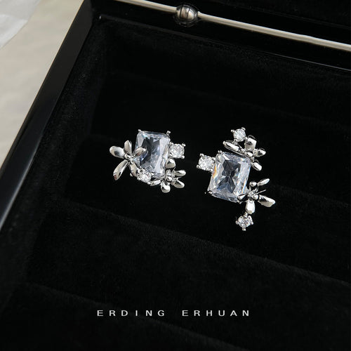 Silver asymmetric rectangle CZ floral studs in black jewelry box