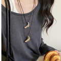 Silver Metal Croissant Pendant Black Cord Necklace view 1