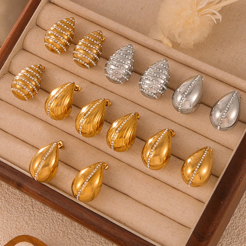 Mixed gold and steel teardrop crystal stud styles in velvet tray