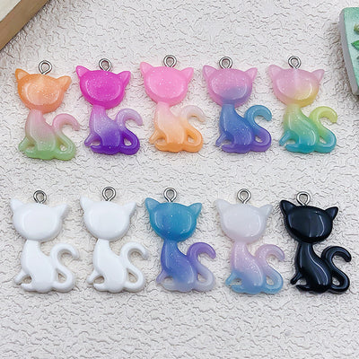 Colorful cat charms arranged on a light background