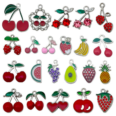 Colorful strawberry and banana charms arranged on a light background