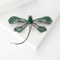 Green Dragonfly Metal Brooch with Dark Green Wings, a Pink Center Stone, and Curved Tail view 2