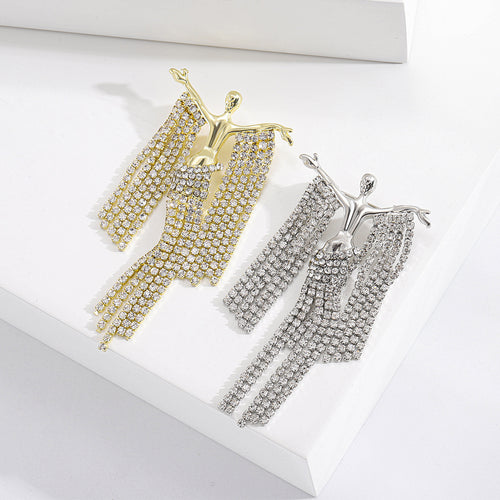Gold and silver crystal fringe dancer brooches pair on white blocks