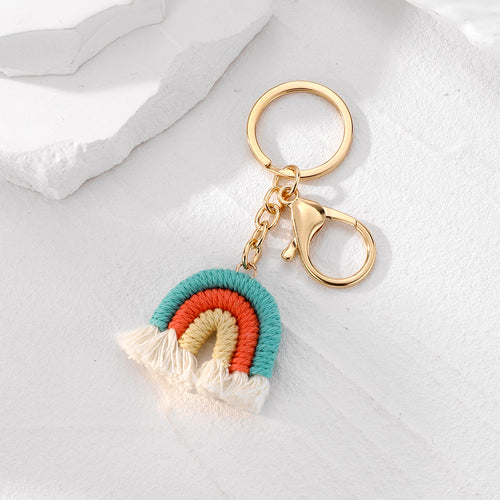 Close-up showing the colors and surface details of gold Tone Macrame Rainbow Split Ring and Clip Keychains