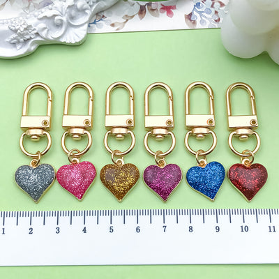 Image 1 showing a bunch of heart shaped key chains.
