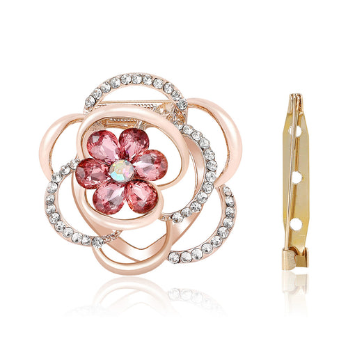 Angled detail view of the layered openwork flower with crystal loops and a faceted floral center brooch