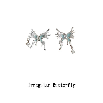 Silver irregular butterfly blue enamel studs on white background