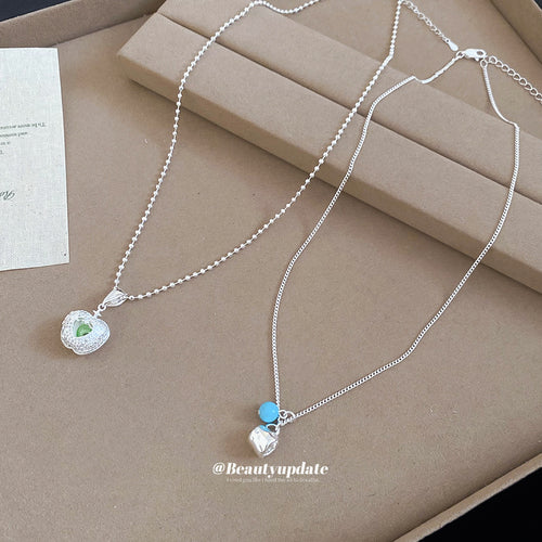 Modeled view of apple pendant necklaces