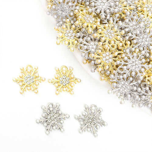 Assorted snowflake charms arranged on a white surface