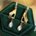 Gold Tone Hand Motif Drop Earrings Holding Pearl Drops view 3